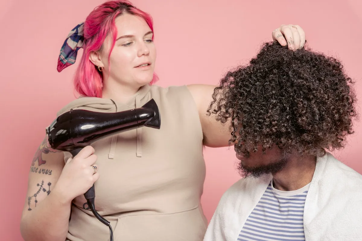 Curly hair being dried with a diffuser