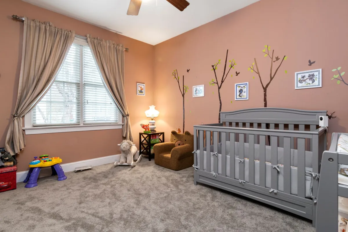 Nursery with a cot beside a window
