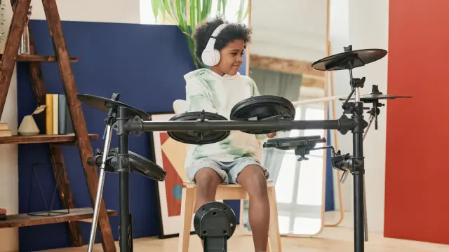 Child wearing headphones while doing schoolwork at a table
