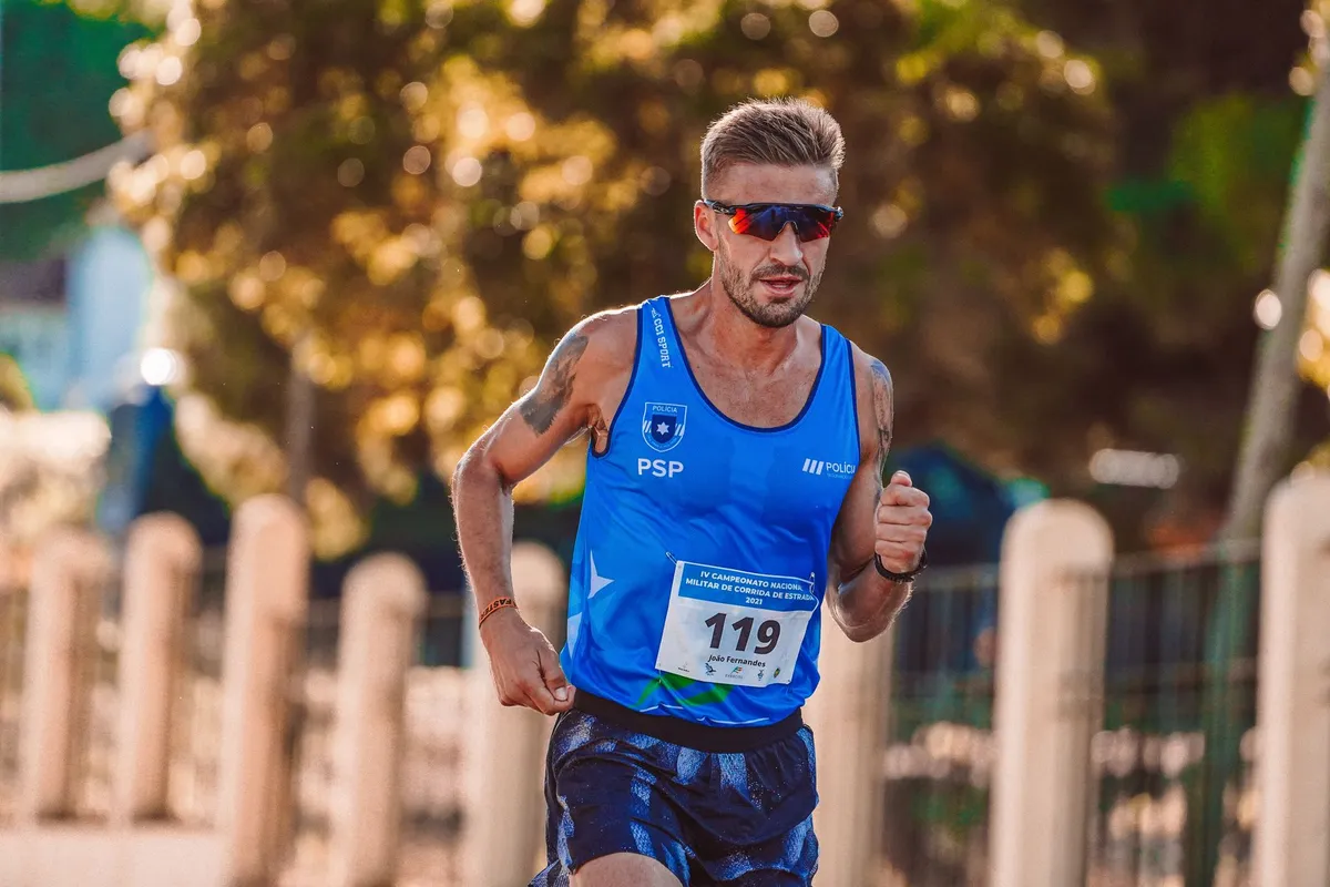 Person running outdoors wearing sunglasses