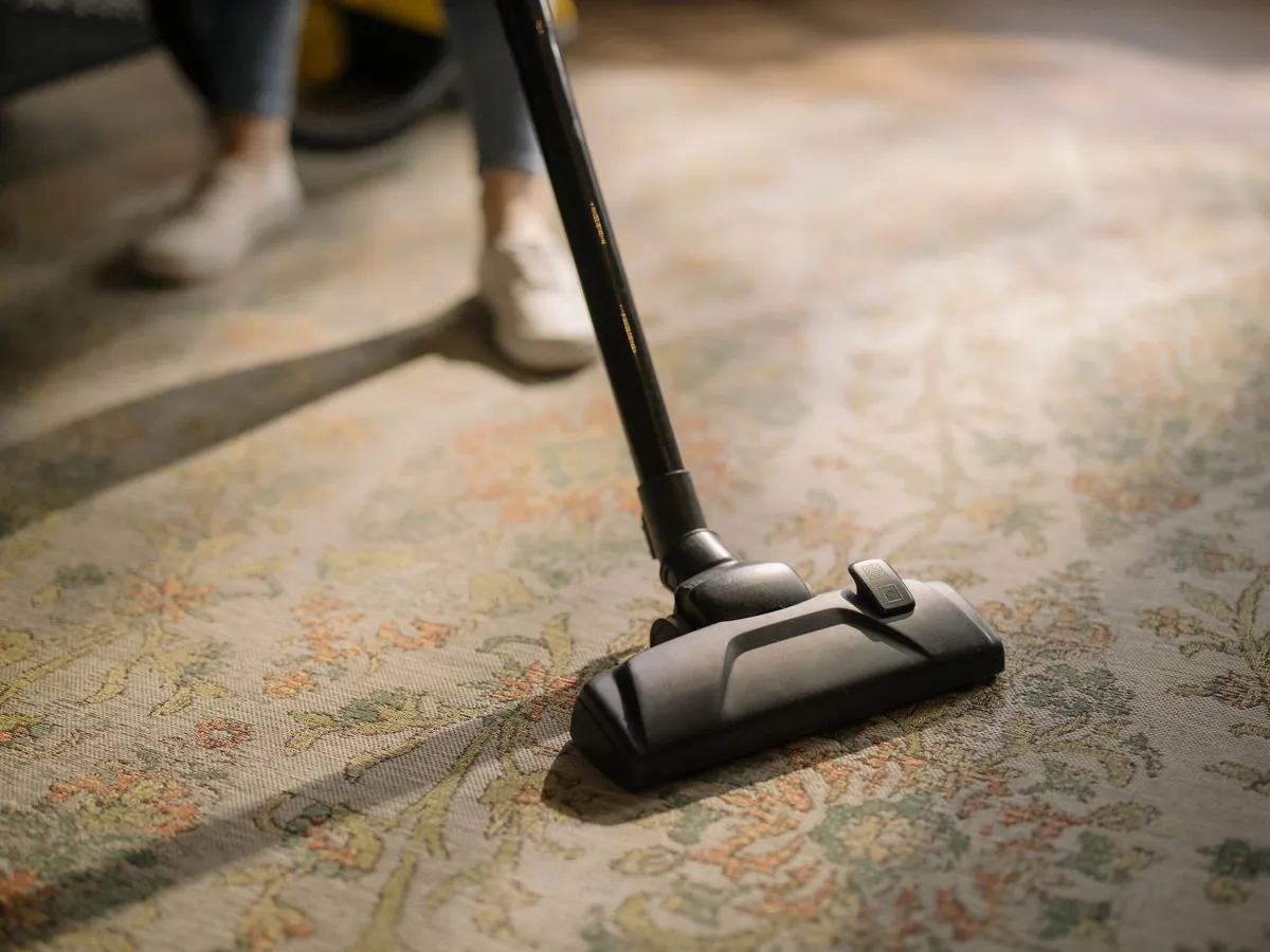 A robot vacuum crossing the edge of a rug