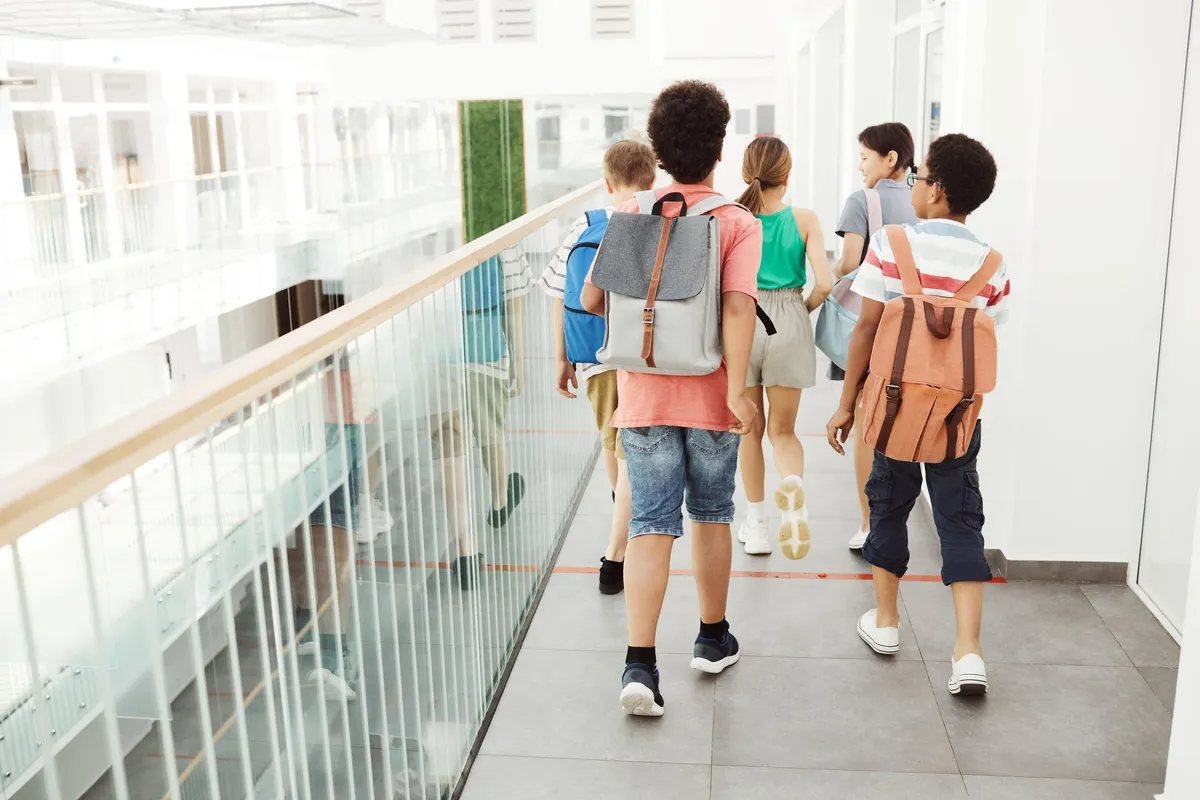 Children walking to school wearing backpacks