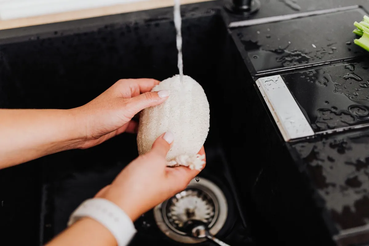 Hand washing a basket with a soft sponge