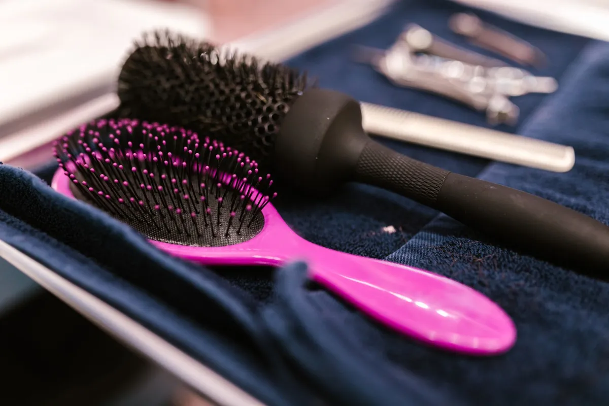 Flat iron and brush on a bathroom counter